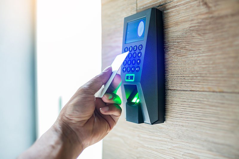 door,access,control.,staff,holding,a,key,card,to,lock